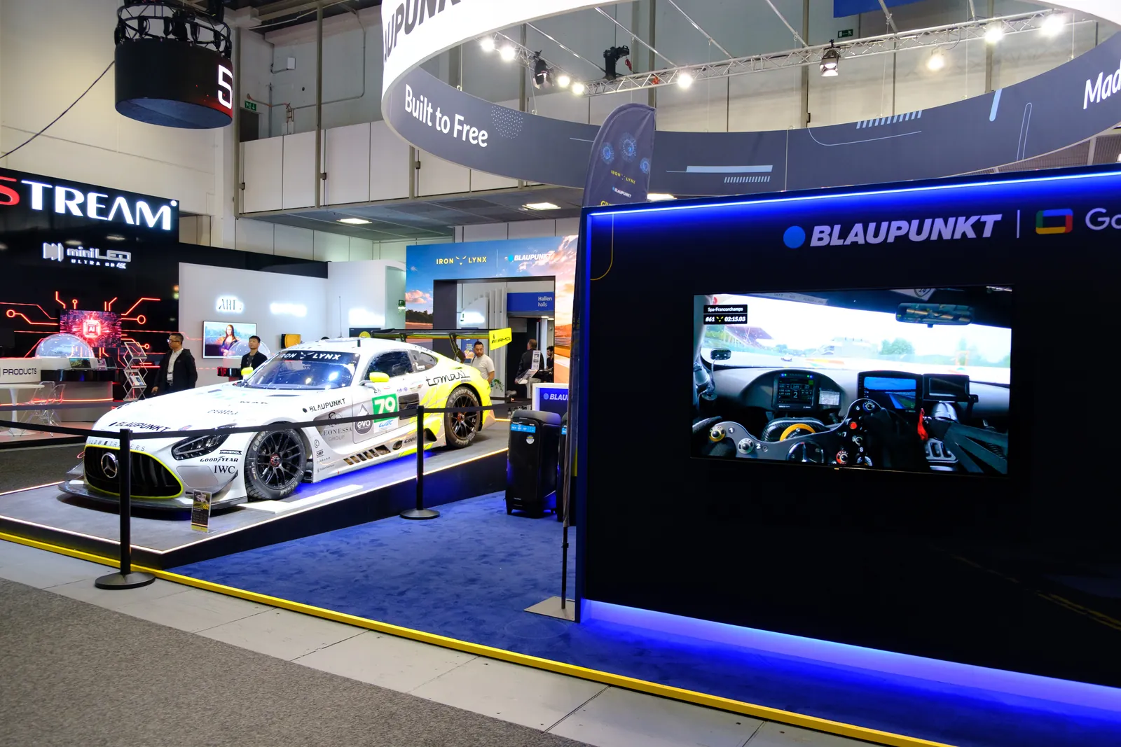 Iron Lynx Mercedes-AMG race car next to the Blaupunkt Google TV wall at IFA 2026
